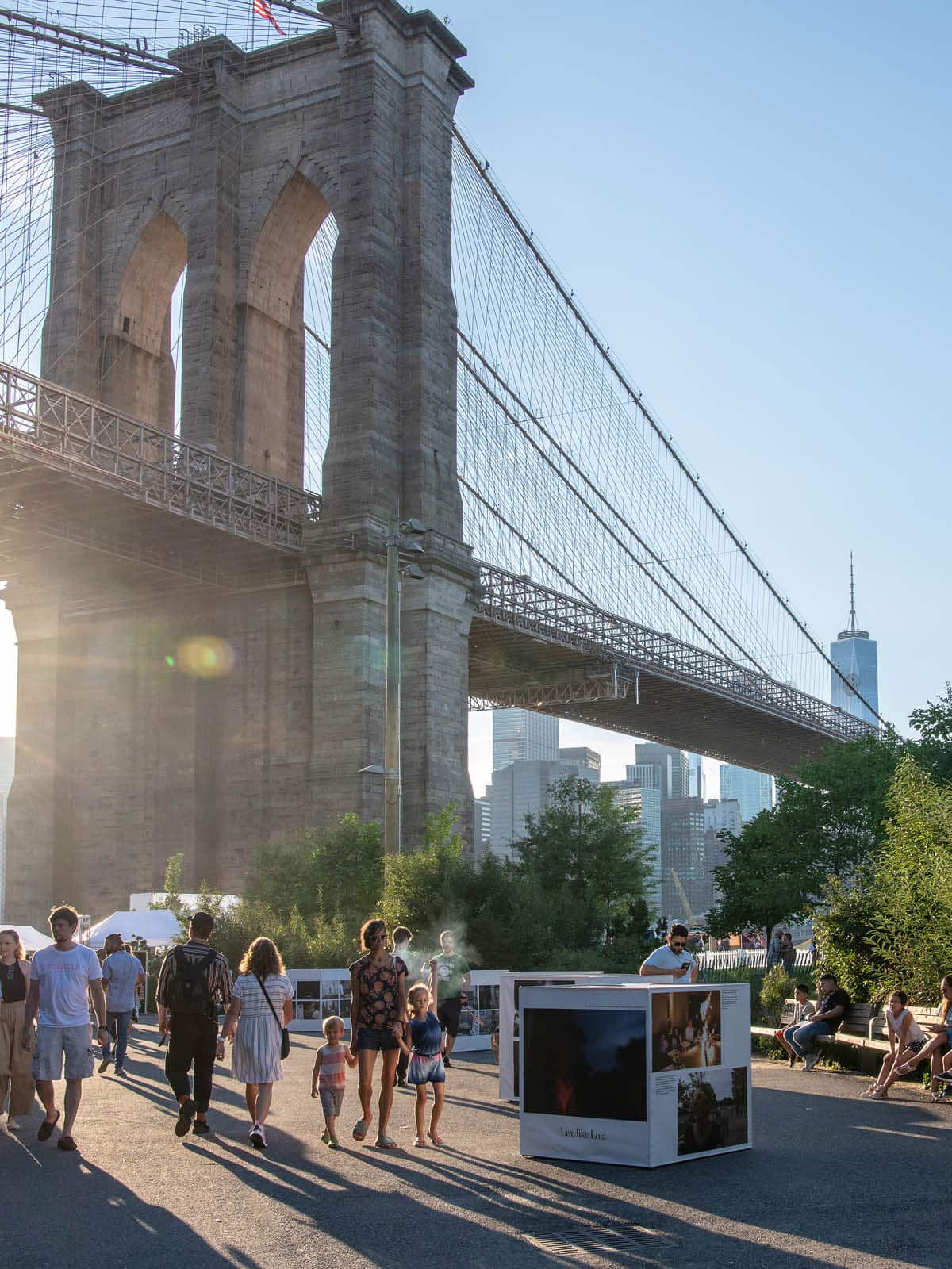 Cube shaped displays with photos on the pathway under the Brooklyn Bridge as a part of the Photoville exhibition.
