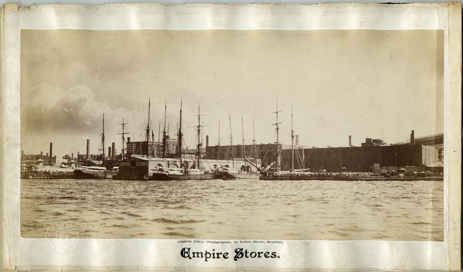 Historical photo of the Empire Stores seen from the water.